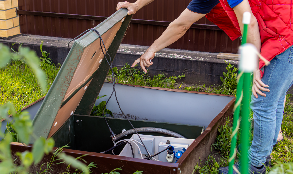 Homeowners pointing to an issue with their septic in their yard