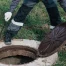 Worker opens septic well manhole cover for septic tank maintenance.